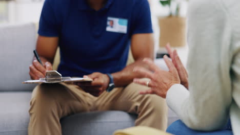 Nurse-consulting-patient-writing-on-clipboard