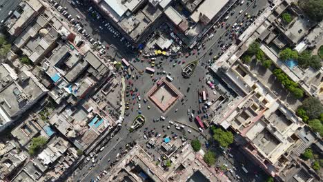 overview top shot of highway junction with traffic below passing through the city