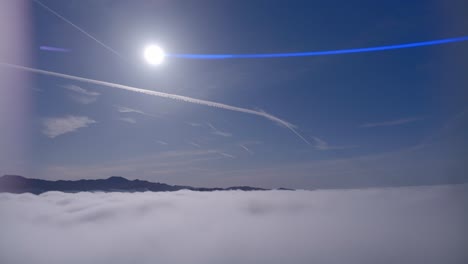 Breathtaking-aerial-view-as-the-drone-skims-atop-fluffy-clouds-against-a-vibrant-blue-sky-on-a-sunlit-day