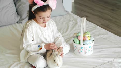 child and rabbit spending easter morning in bed