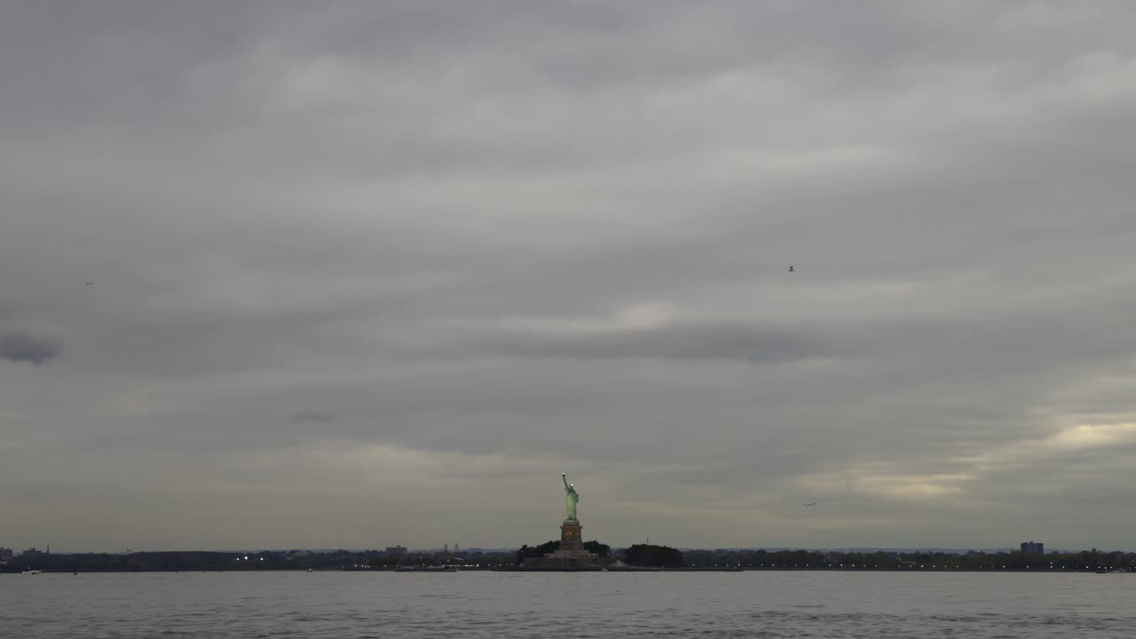 Wide angle view of Liberty Island on cloudy evening