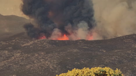 Black-smoke-rises-over-the-flames-of-the-Fairview-Fire,-forest-fire,-in-California