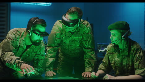 two soldiers walking in data center corridor. one holds tablet computer, they have discussion. rows. two soldiers walking in data center corridor. one holds tablet computer, they have discussion. rows of working data servers by their sides