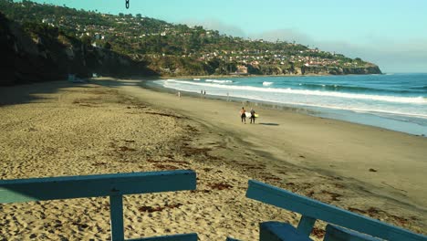 Life-Guard-Point-Of-View-With-Surfers-Walking-On-Beach-Ocean-Waves