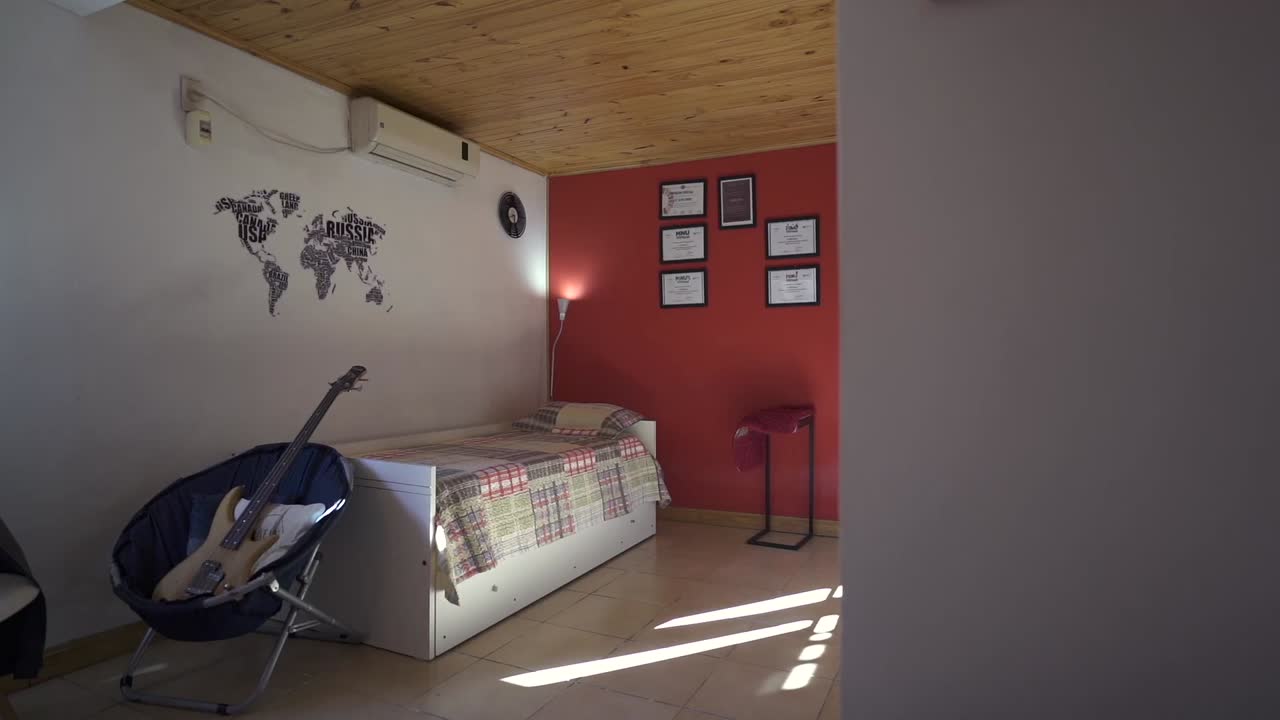 Vibrant Airbnb house bedroom with travel decor, featuring statement guitar and a bed. Perfect for creative rental listings.