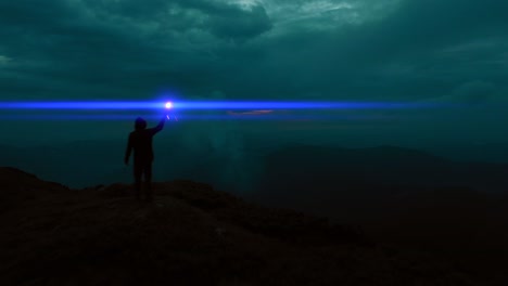 the man holds a blue fire stick on the mountain top