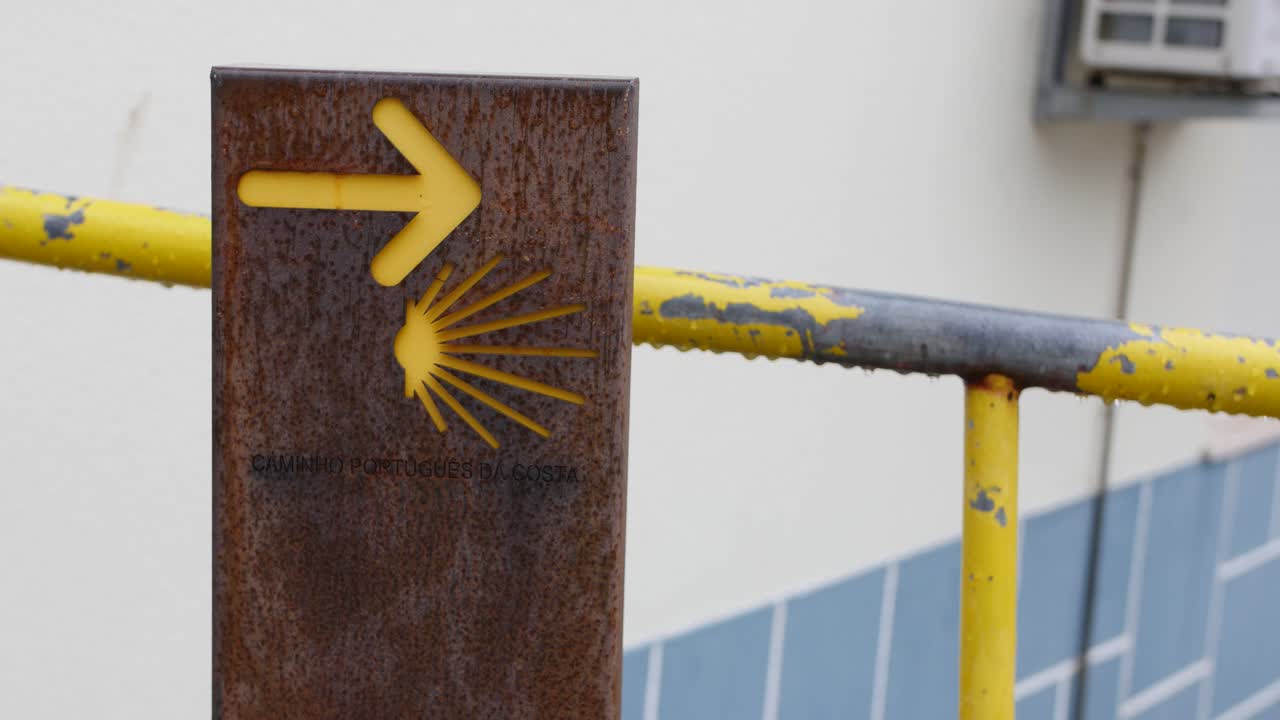 Plate with yellow arrow indicate the way of Camino de Santiago known in English as Way of Saint James.