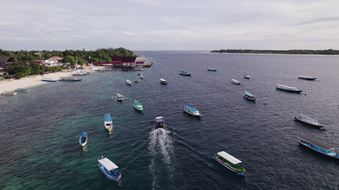 Aerial view of a boat moving between vessels on the coast of Gili Trawangan
