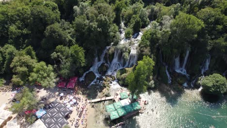 kravica waterfall oasis with visitors in bosnia