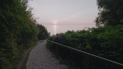 Sandy-Stairway-Down-To-Sunrise-at-Knäbäckshusen-Beach-in-South-Sweden-Österlen,-Static-Wide-Shot