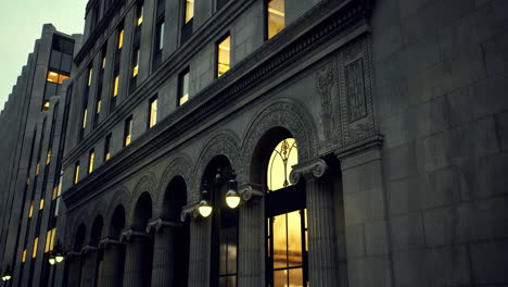 architectural details of historic building with glowing windows at dusk