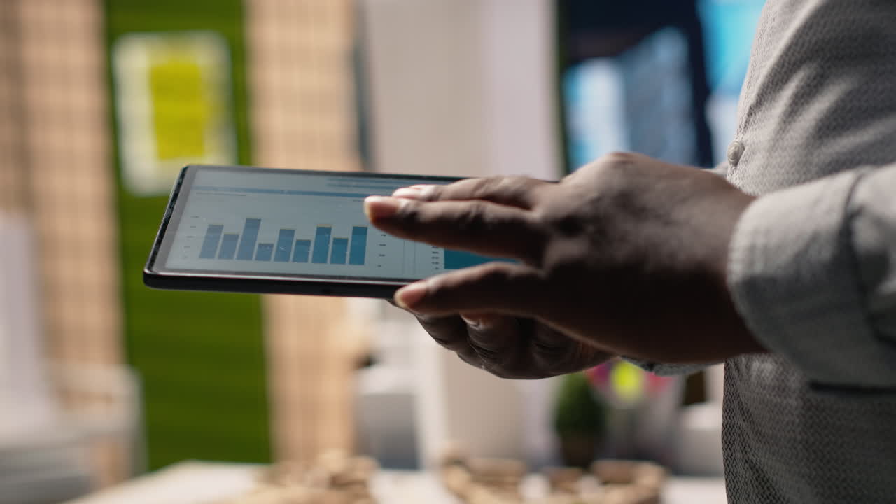 Vertical Video Close up of black professional uses architectural software on tablet