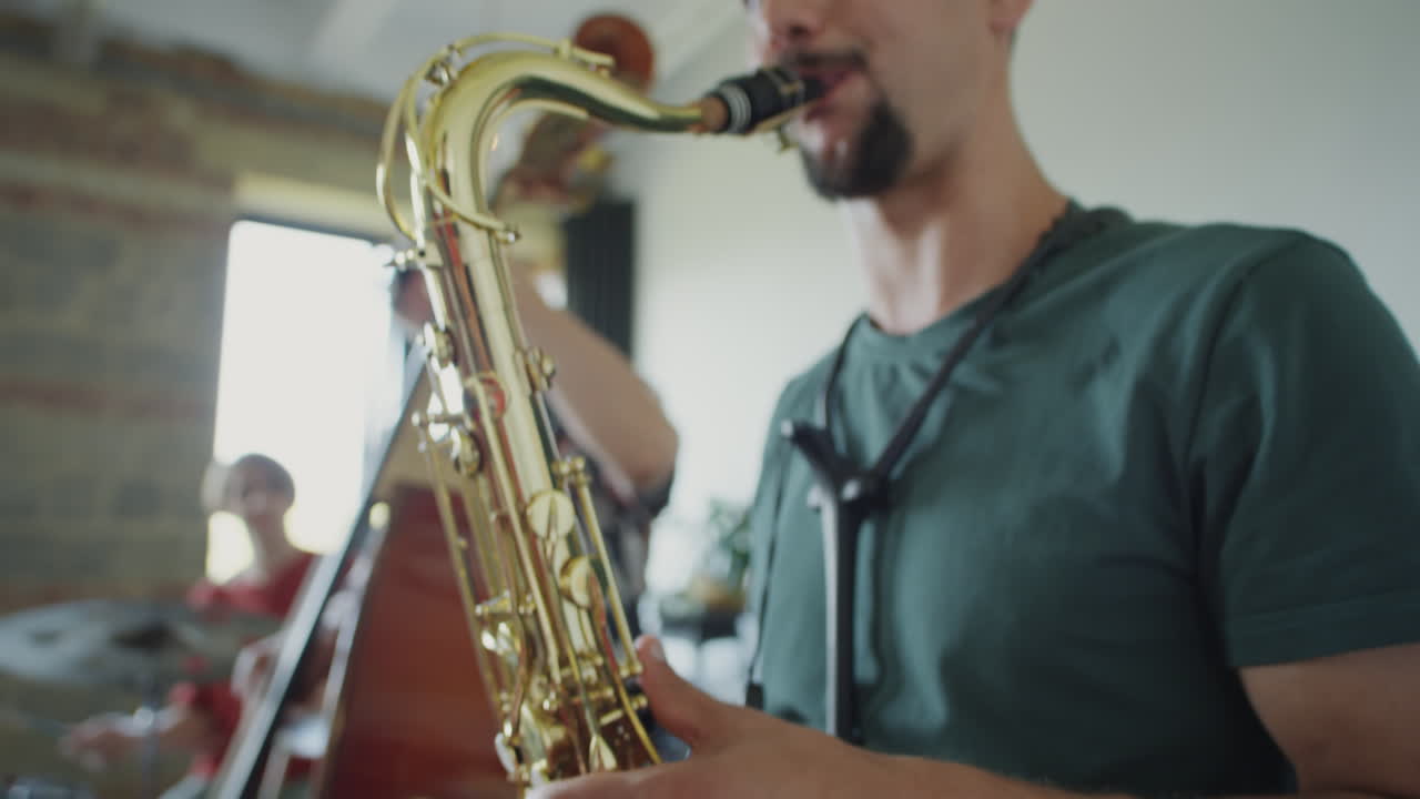 A group of musicians playing jazz music together, with a focus on a saxophonist