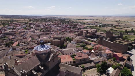 Panoramic-aerial-view-of-open-landscape-with-village-of-Oropesa-in-foreground