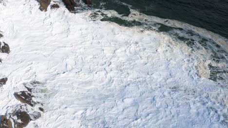 coastal waves and foam from aerial view