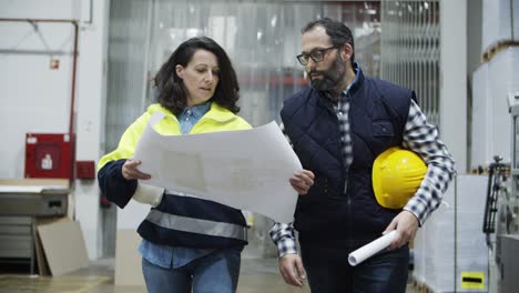 focused technicians discussing new interior of printing house