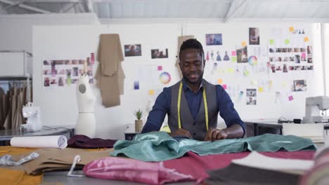 mixed race man working in fashion office