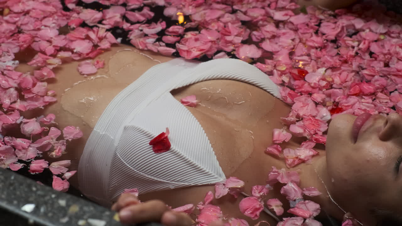 Woman Relaxing in a Rose Petal Bath
