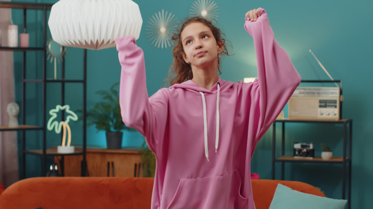 School girl listening music dancing trendy dance disco party having fun celebrating at home