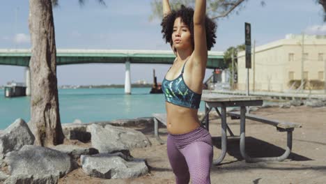 relaxing black girl with hands apart training outside