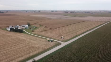 Aerial-drone-view-in-rural-Iowa-with-a-farm-with-barns,-silos-and-corn-fields