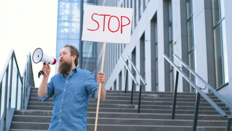 kaukasischer mann, der über einen lautsprecher spricht und ein schild mit der haltestelle "auf der straße" hält