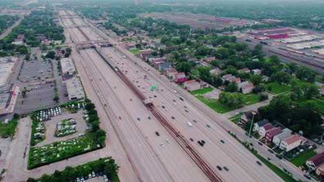 majestic aerial of traffic flow above highway i-90 and cta garfield subway red line from south side chicago looking south towards west woodlawn