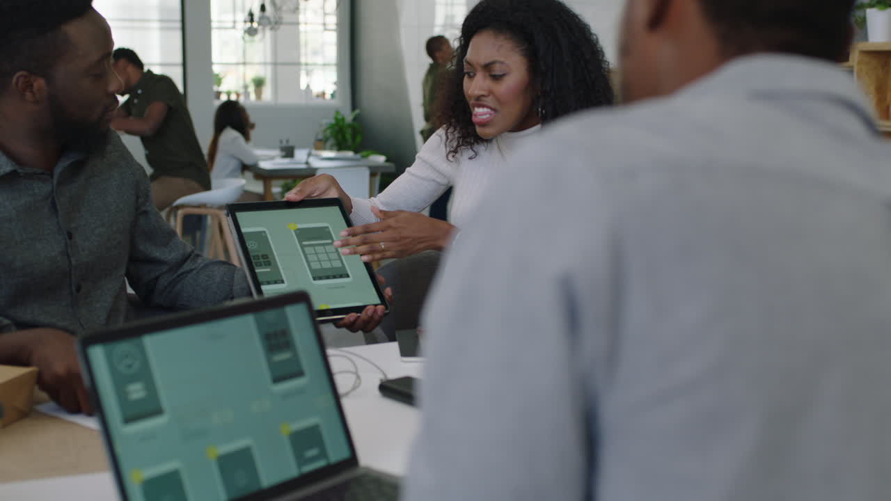 young african american business people meeting software developer team design mobile application colleagues brainstorming sharing creative ideas using tablet computer collaborating in startup office