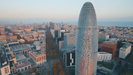 aerial view of a modern glass building in barcelona city by the sea