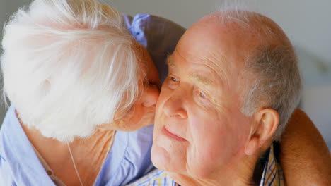 close-up of caucasian senior woman kissing senior man at comfortable home 4k