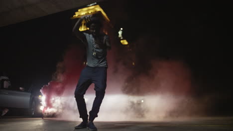 African-American-male-dancing-in-smoke-and-headlights