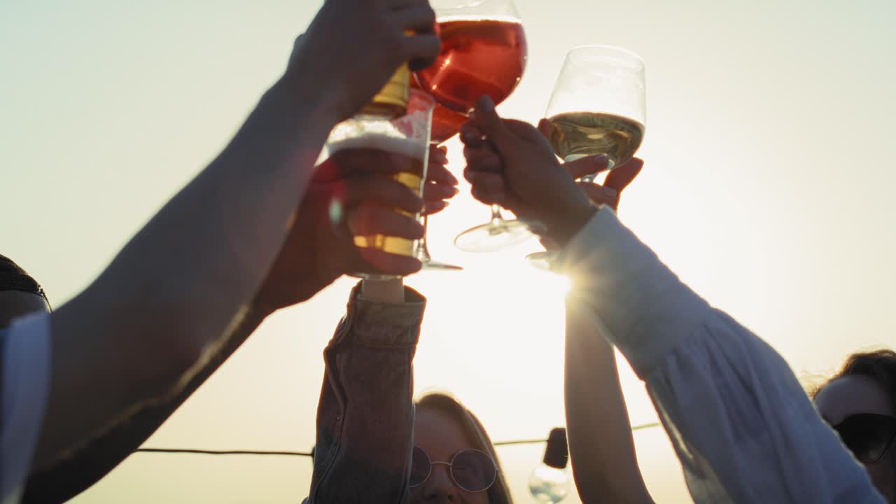 Group of friends make a toast at sunset in the city.