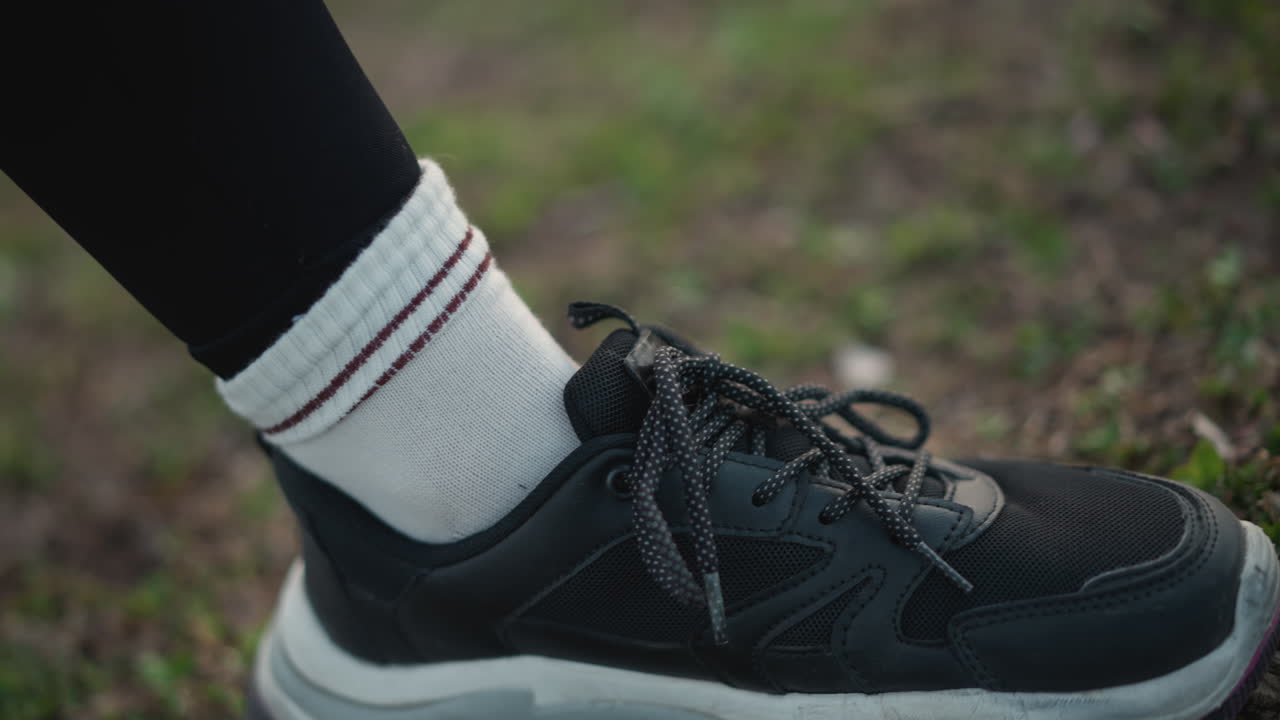 Sportsman Readying For Running Event, Preparation Scene Of Athlete Adjusting Socks And Accessories On Track, Closeup Of Sports Participant Fixing Socks And Jewelry Before Sprint Initiation