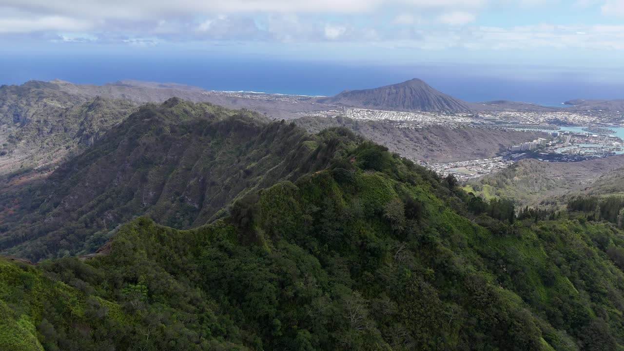 Drone flying above the high mountain peaks on Oahu, Hawaii, Dramatic tropical mountains and scenic island coastline