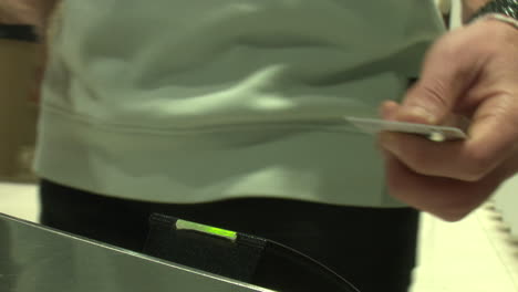 person using card reader at entrance