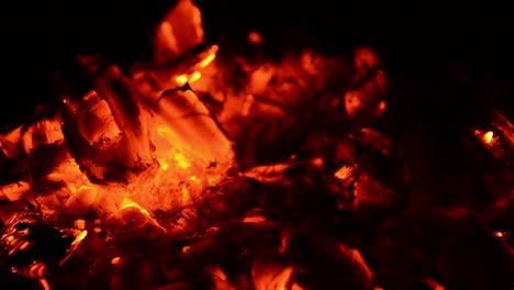 Blowing-at-burning-wood-to-get-a-campfire-going,-getting-more-oxygen-to-support-a-burn-rate-that-keeps-the-temperature-of-the-fire-wood