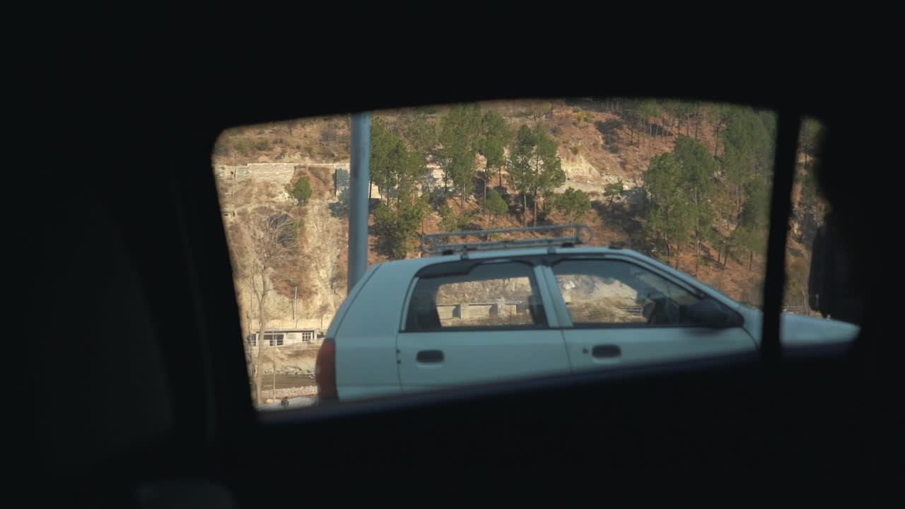vista de la ventana del coche en cámara lenta fuera de las montañas himachal y la silueta de una pareja conduciendo en la india cinemática