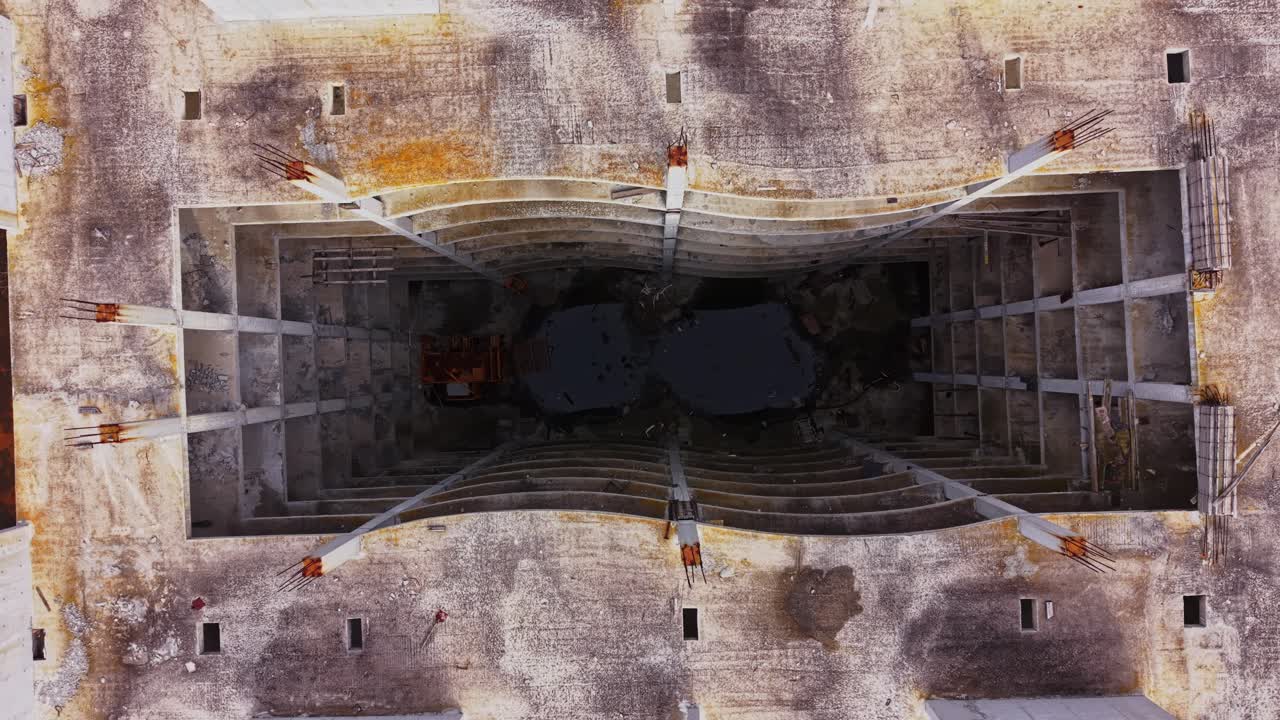 Construction site view from above showing structural elements and machinery