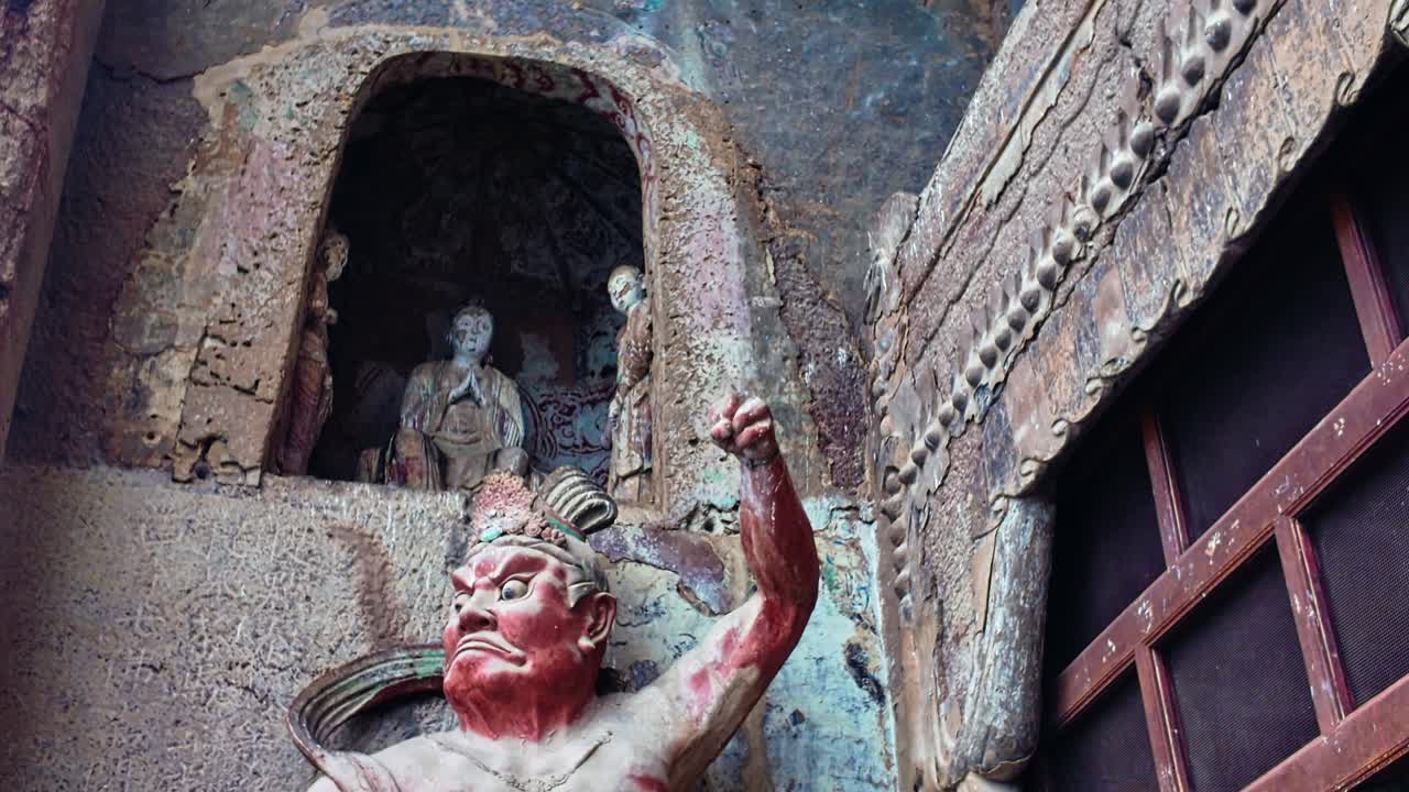 Giant Buddhist Guardian Warrior Sculpture Inside A Cave At The Maijishan Grottoes In Tianshui, Gansu Province, China. Tracking Shot