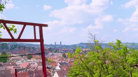 rural-view-of-town-of-Stuttgart-with-suburbs,-red-gate-and-lush-green-trees-in-foreground