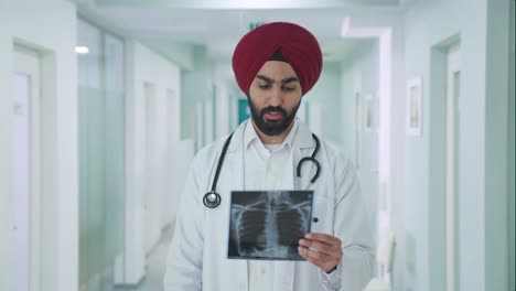 serious sikh indian doctor checking x ray report