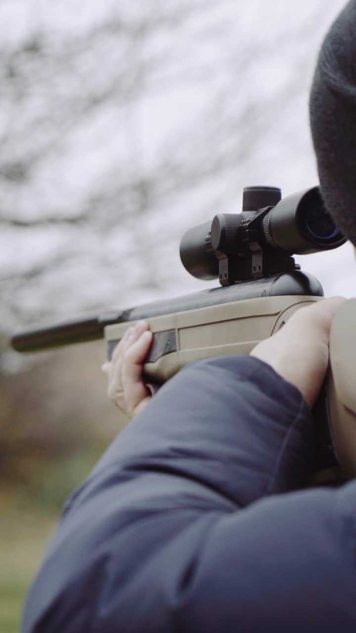 Hunter with gun on forest. Close up of the hunter man shooting with hunting rifle on nature