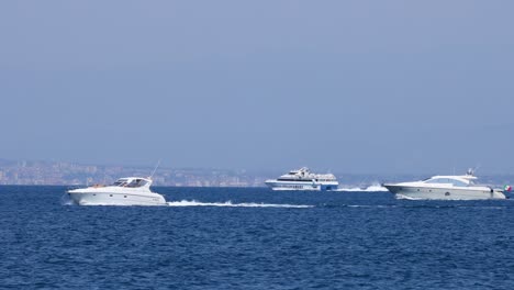 two boats moving across the sea in naples