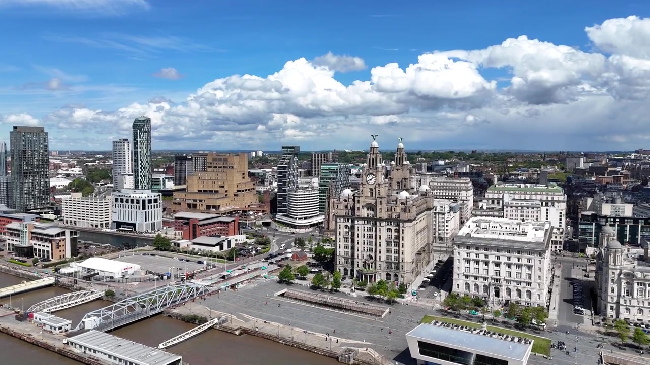 Vista aerea ascendente con drone del lungomare di Liverpool con cielo azzurro.