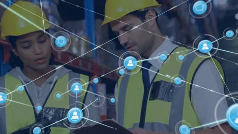 Animation-of-network-of-connections-with-icons-over-diverse-workers-talking-in-warehouse