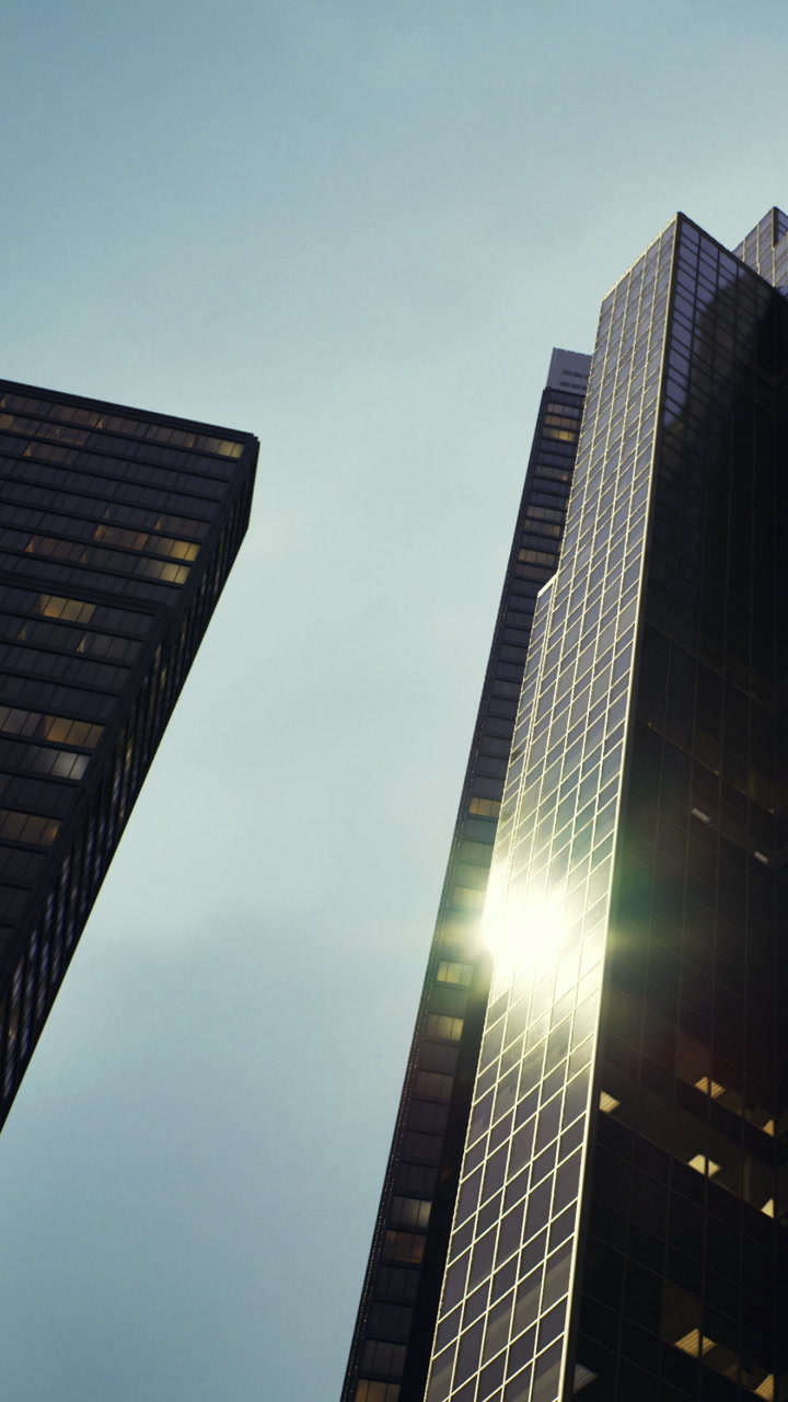 Skyscrapers reflecting sunlight in an urban setting during daytime hours