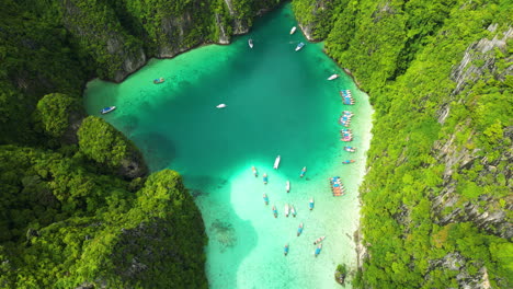 aerial top down of scenic maya bay in phi phi islands thailand travel destination drone fly above isolated tropical beach with boat moored at bay in southeast asia