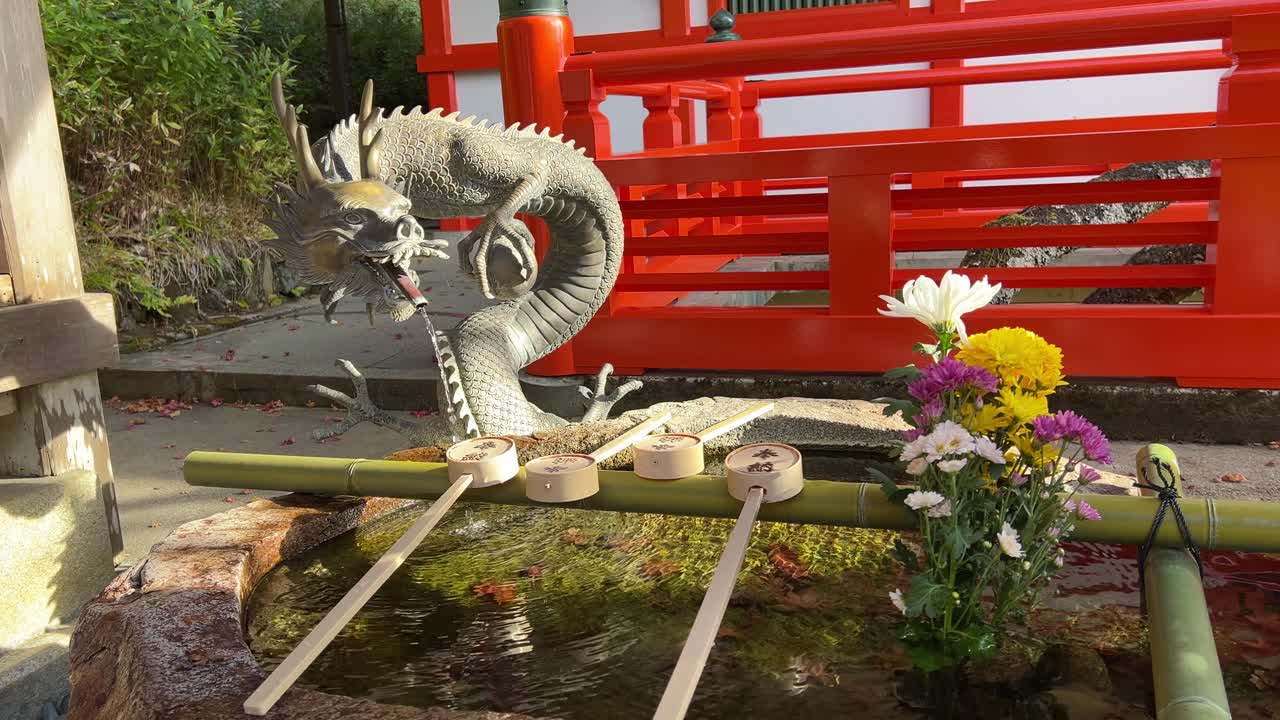 Dragon statue with typical Japanese ladle at Shinto Shrine