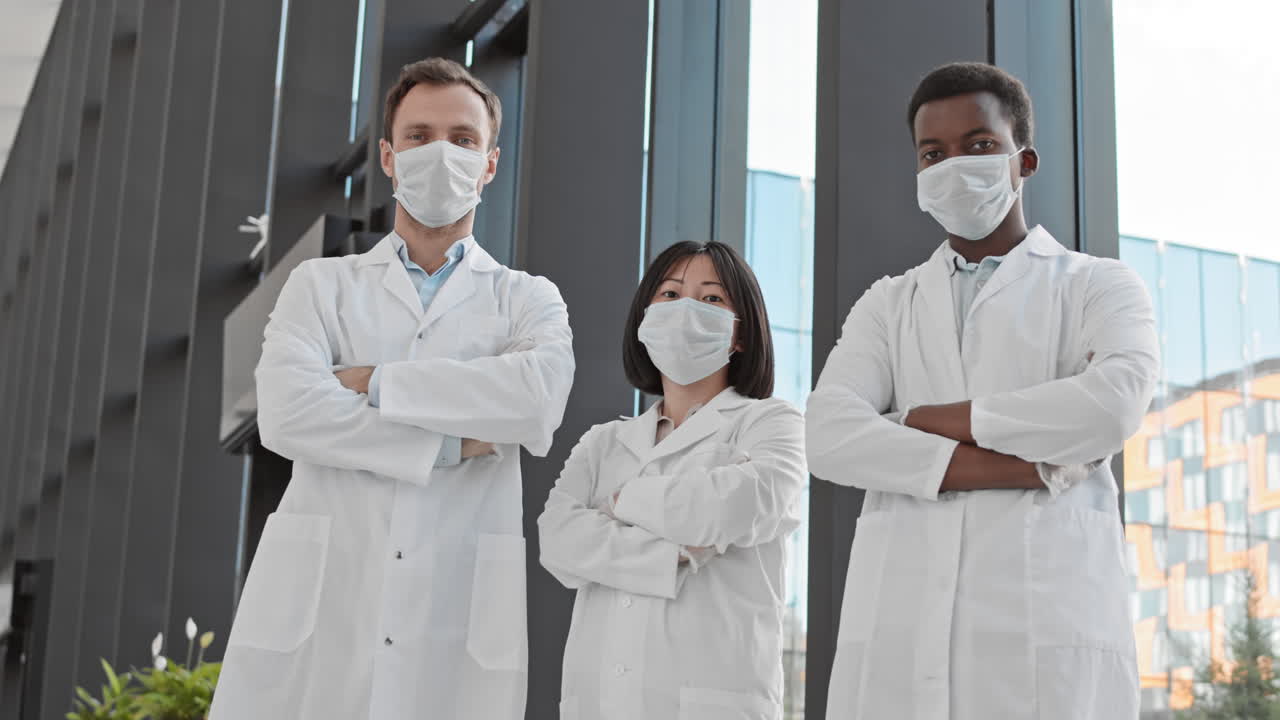 Team of Three Biologists in Modern Hospital