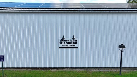 downtown self storage sign on warehouse building with phone number